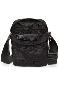 Borsa a tracolla in tessuto nero con accenti in rete. Presenta un compartimento principale con tasca con zipper e una tracolla regolabile. Texture liscia, design compatto.