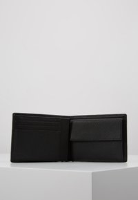 Black leather wallet with a textured finish, featuring multiple card slots and a larger compartment for notes or receipts.