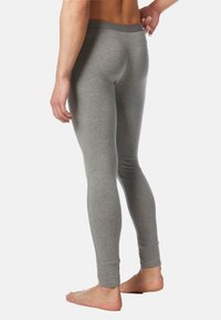 Graue Leggings aus weichem, dehnbarem Stoff mit einer schlanken Passform und schmalem Bund, in einem schlichten, einfachen Design.