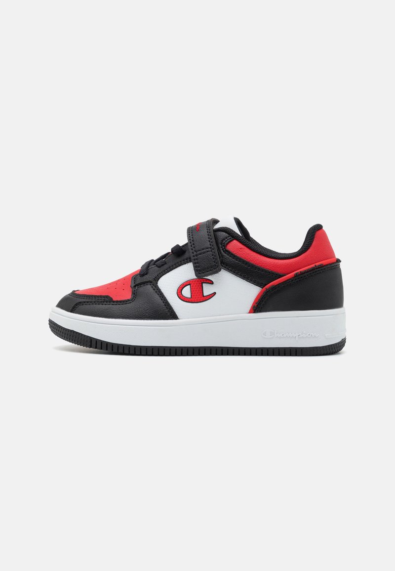 Svart, rød og hvit sneaker med polstret krage, teksturlær og borrelås. Har en gummisåle med logo-detaljer.