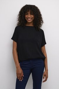 Black short-sleeve top with a loose fit and a straight neckline, paired with navy blue jeans. Soft texture and simple design.