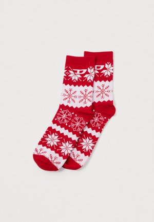 Meias de lã tricotadas em vermelho e branco, com padrões de flocos de neve e desenhos em zigue-zague. Feitas de material suave, adequadas para uso no inverno.