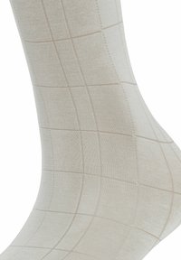 Beige Socken mit einem Muster im Karodesign. Hergestellt aus einem glatten Stoff, mit dezenten Nähdetails und einer engen Passform.