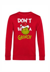 Červená mikina s dlouhým rukávem s bílým a zeleným nápisem "NEBUĎ GRINCH" a ilustrací Grinche s vánoční čepicí. Bavlněný materiál.