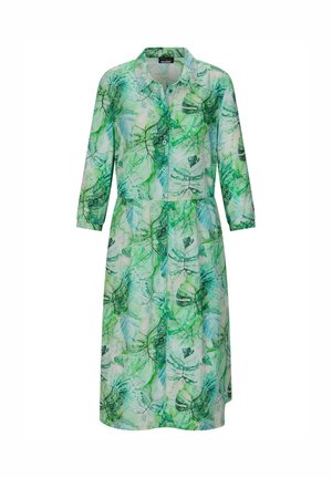 Grünes und weißes knöpfbares Kleid mit langen Ärmeln und einem tropischen Blattmuster, das unter die Knie reicht.