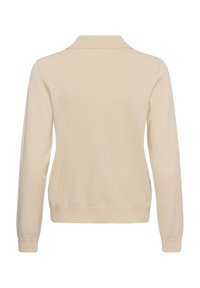 Cardigan beige à manches longues avec motif à points texturé sur les manches, poignets et ourlet côtelés, et un petit col vu de dos.