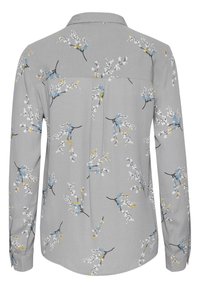 Grijze langemouwen shirt met een bloemenpatroon met witte, blauwe en gele accenten. Soepele textuur met een kraag en achterkant met plooidetail.