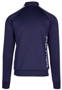 Marineblauwe sportjack met lange mouwen, hoge kraag, witte accenten op de schouders en het "GORILLA WEAR" logo verticaal op de zijkant gedrukt.