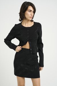 Black ribbed co-ord set featuring a cropped button-up cardigan and a fitted mini skirt, both with a subtle pattern and textured fabric.