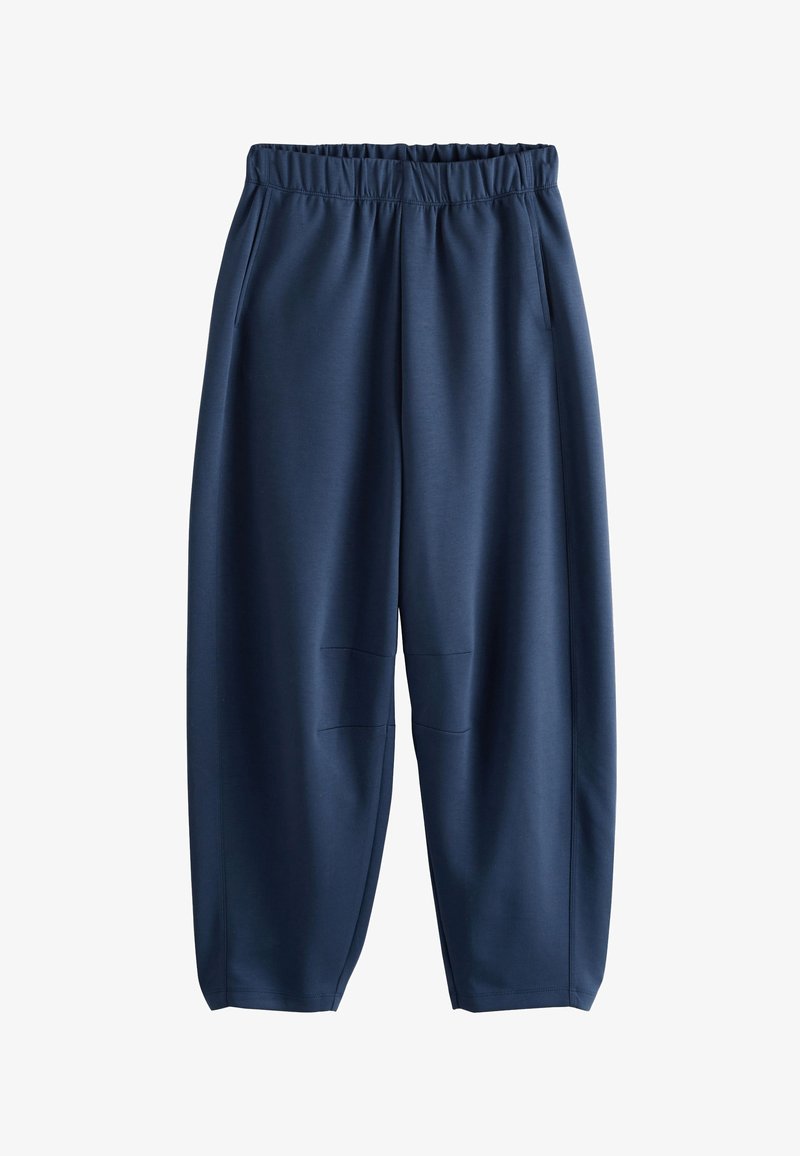 Pantalon bleu marine avec taille élastique, poches latérales et jambes décontractées légèrement resserrées, en tissu lisse.