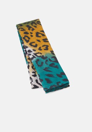 Tela doblada con estampado de leopardo en degradado que pasa de verde y amarillo a azul verdoso y blanco sobre un fondo claro.