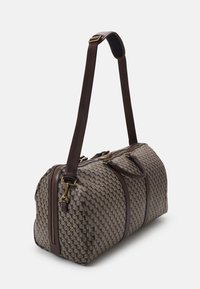 Woven brown and beige duffle bag with two sturdy brown handles, adjustable shoulder strap, and gold hardware accents. Zippered compartments on top.