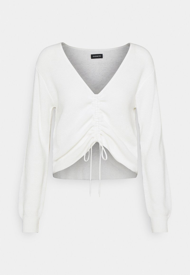 Witte cropped sweater met een V-hals, lange pofmouwen, geplooide voorkant en verstelbare koord aan de zoom. Zachte, gestructureerde stof.