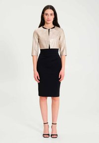Black pencil dress with a fitted silhouette, complemented by a cropped, metallic gold jacket with three-quarter sleeves and a round neckline.
