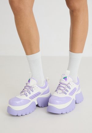 Chunky sneakers in white and lavender. Features a glossy finish, thick soles, purple accents, and a grape logo on the tongue.