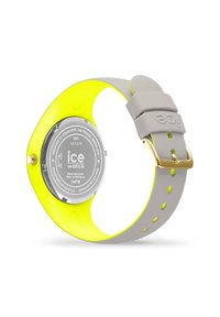 Orologio rotondo con retro trasparente, cinturino in silicone grigio e dettagli in giallo brillante; presenta una chiusura classica e una resistenza all'acqua di 10 ATM.