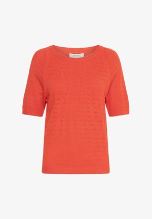 Pull en tricot à manches courtes couleur corail orange, présentant un motif texturé avec de petits trous, un col rond et des bords côtelés.