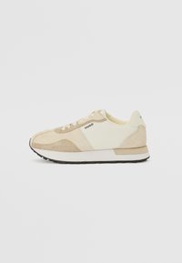 Beige sneakers with textured suede and mesh panels, featuring a white sole and light laces. Marked with "HUGO" on the side.