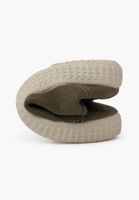 Green woven slip-on shoes with a thick, textured cream sole and rounded shape, showcasing stitched detailing and a soft interior lining.
