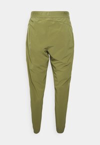 Nike olivgrüne Hose mit taillierter Passform, elastischem Bund und gerippten Knöcheln, aus leichtem, glattem Material gefertigt.