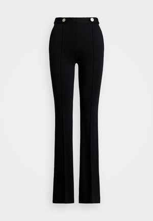 Black flared pants made of stretch fabric, featuring a high waist, two front pockets, and silver button accents at the waist.
