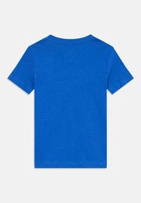 T-shirt a maniche corte in cotone blu brillante. Presenta un collo rotondo e un design semplice senza ulteriori motivi o dettagli.