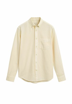 Baumwoll-Hemd mit langen Ärmeln in blassgelb, mit Knopfkragen, einer einzigen Brusttasche und abgerundetem Saum. Keine sichtbaren Muster oder Akzente.