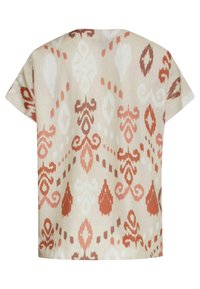 Short-sleeve top in light beige, featuring a red and white abstract ikat pattern, with a loose fit and soft, textured fabric.