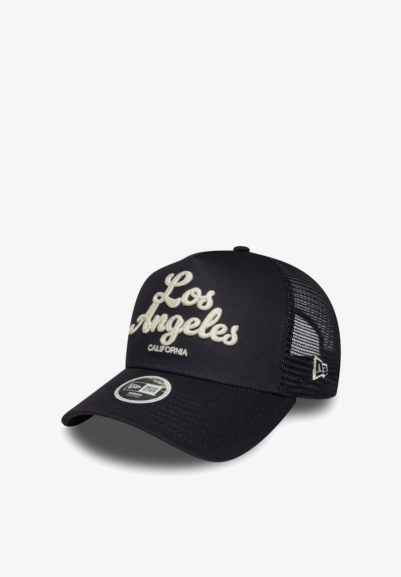 Black trucker cap with mesh back, curved brim, and "Los Angeles California" embroidered in beige on the front panel.