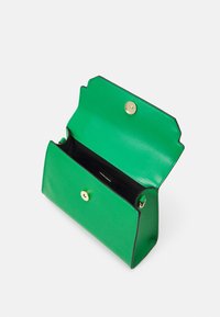 Green leather handbag with an open flap, gold hardware closure, and a black interior. Features a structured shape and smooth texture.