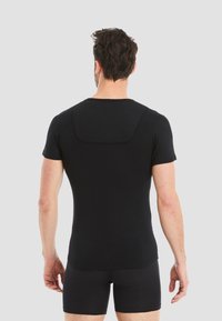 Black short-sleeve athletic shirt featuring a rounded neckline and seamless back design. Made of soft, lightweight material for comfort.