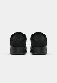 Mustad mustad Nike Air sneakersid on mustrine disain, ümar konts, pehmendatud krae ja reljeefne logo taga. Sile sünteetiline materjal.
