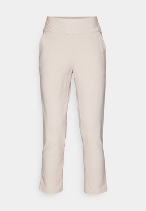 Helle beige, schmal zulaufende Hose mit breitem Bund, weicher Textur, seitlichen Taschen und umgeschlagenen Säumen. Geeignet für legere oder semi-formelle Anlässe.