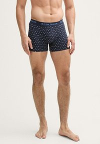Boxers bleus avec un motif, ceinture élastique arborant le logo "TOM TAILOR" et une coupe ajustée.
