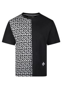Schwarzes T-Shirt mit einem geometrischen Schwarz-Weiß-Muster auf einer Seite. Hergestellt aus Baumwolle, hat es einen Rundhalsausschnitt und kurze Ärmel.