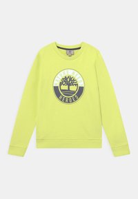 Sudadera amarilla brillante de manga larga, con puños y dobladillo acanalados, que presenta un diseño gráfico circular que dice "LA NATURALEZA NECESITA HÉROES."