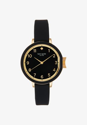 Montre ronde noire avec chiffres, aiguilles et bordure dorés, bracelet noir et logo "kate spade NEW YORK" sur le cadran.