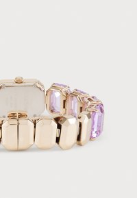 Gold-tone watch with a rectangular case, purple rectangular crystals, and a faceted design. Features a secure clasp and smooth metallic links.