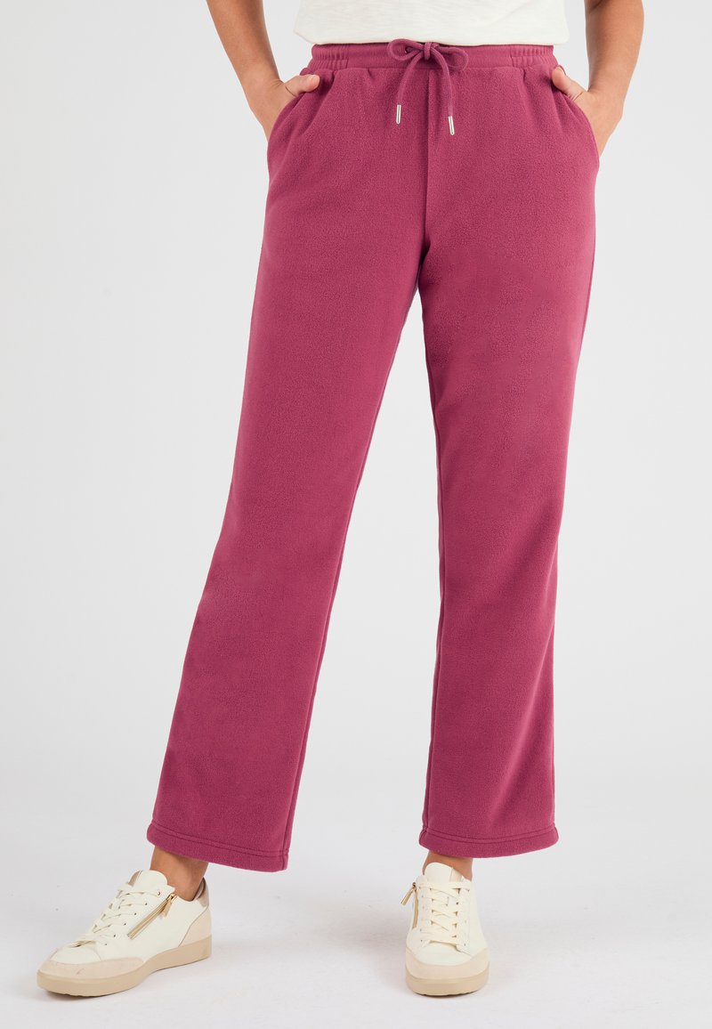 Fleece jogpants in donkerroze met een trekkoord in de taille, zijzakken en een relaxte pasvorm. Glad textuur en recht model.