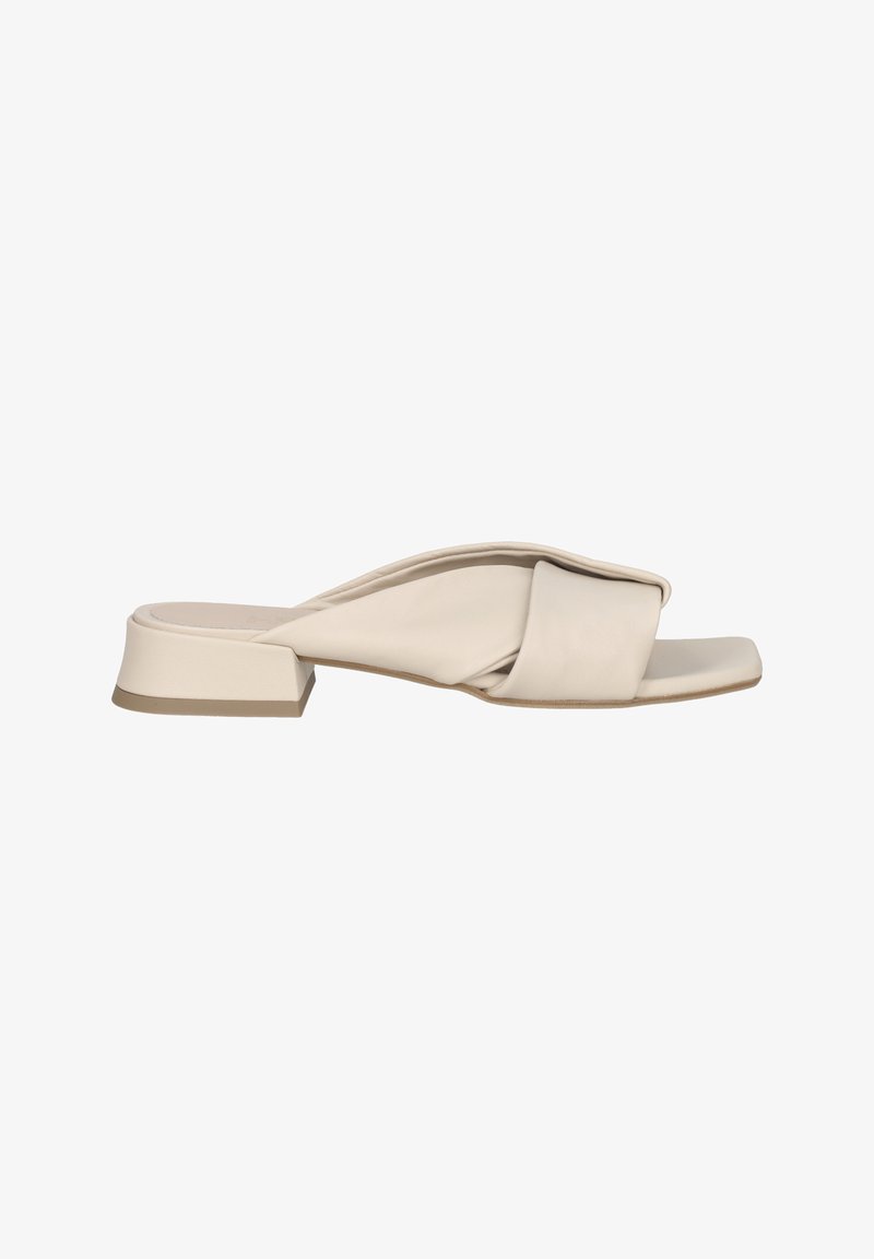 Beige leather slide sandal with a knotted design and a square toe. Features a low block heel and a smooth texture.