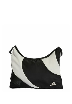 Černobílá kabelka přes rameno s vlnkovým vzorem, vyrobená z odolného nylonu. Má strukturovaný povrch a logo v dolním rohu.