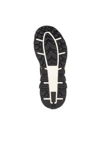 Schwarze Gummi-Schuhsohle mit einem robusten Profilmuster, das tiefe Rillen aufweist, und einem weißen Akzent in der Mitte. Strapazierfähige und strukturierte Oberfläche.