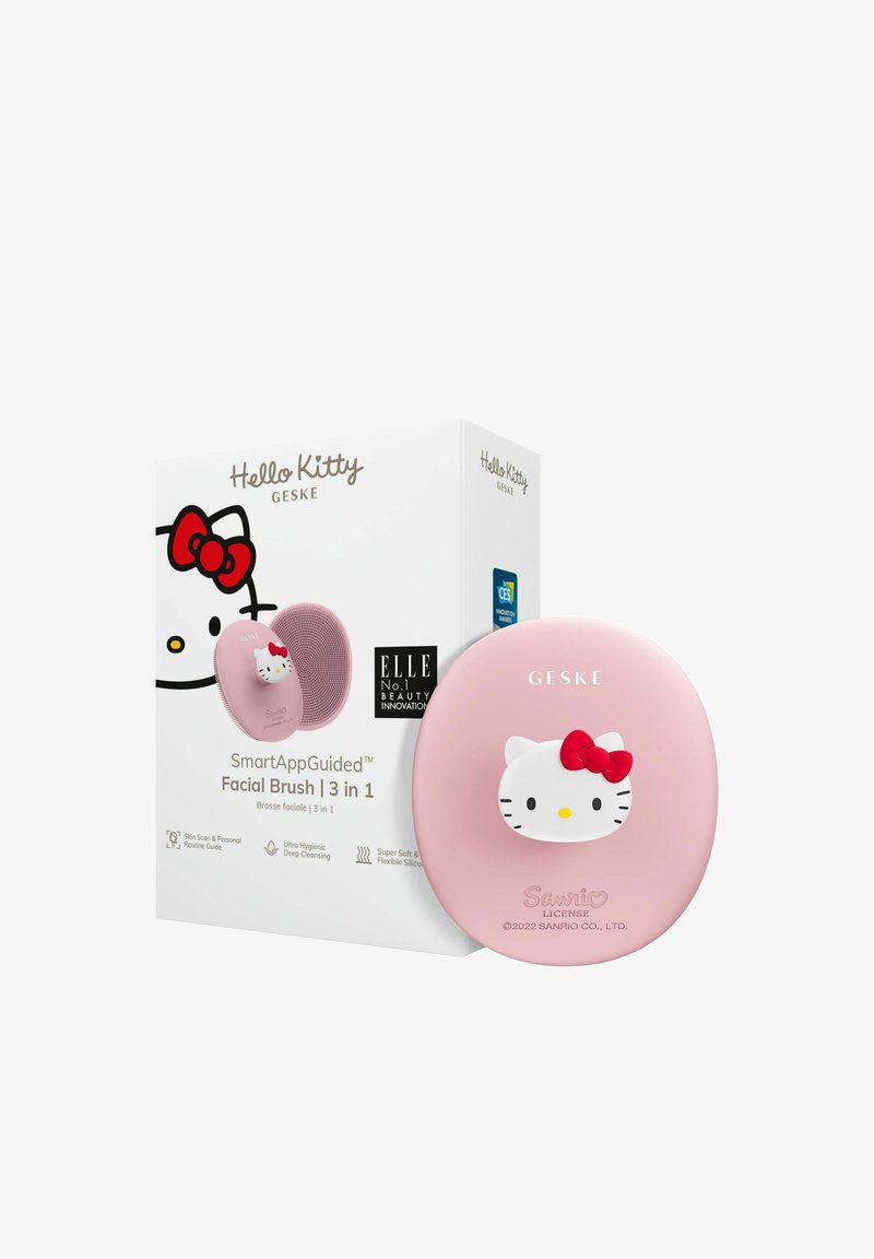Hello Kitty intelligente Gesichtsreinigungsbürste aus hellrosa Silikon mit rotem Schleifenakzent; Verpackung mit grafischem Design und Produktinformationen.