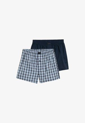 Two pairs of boxer shorts: one in a navy blue solid color, the other with a blue and white plaid pattern. Cotton material, elastic waistband.