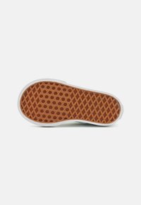 Rubber shoe sole with a brown textured pattern featuring a hexagonal grid design. Edges are white, providing contrast to the sole's texture.
