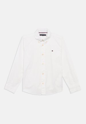 Weißes Hemd mit langen Ärmeln, aus Baumwolle, mit umklappbarem Kragen und kleinem gesticktem Logo auf der linken Brust.