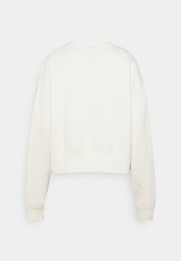 Avklippt, krämfärgad sweatshirt i mjukt material, med rund halsringning och långa, något oversized ärmar.