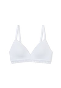 Sujetador inalámbrico blanco con tirantes finos ajustables y una banda elástica decorativa en el borde inferior sobre un fondo liso.