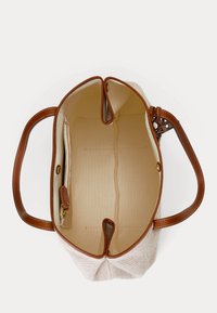 Canvas tas met leren handvatten in bruin, een beige binnenkant en een zijvak met rits, gezien van bovenaf met open bovenkant.