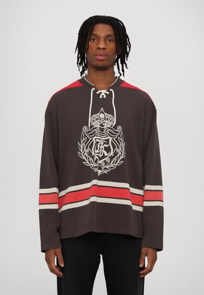 Hooded long-sleeve sweatshirt in dark gray with red accents and white stripes. Features a graphic logo on the front and lace-up neckline.